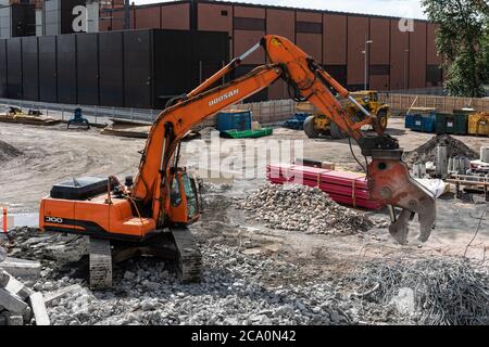 Excavator recycling demolition waste Stock Photo