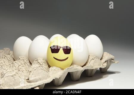 Cool smiley face emoji with dark sunglasses on egg shell Stock Photo