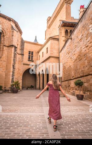 Caucasian blonde strolling very happily in a castle Stock Photo