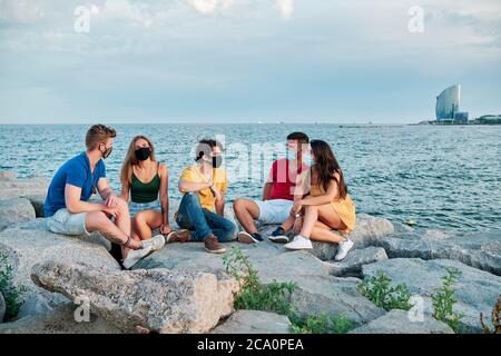 group of young people at sunset in Barcleona Beach Stock Photo