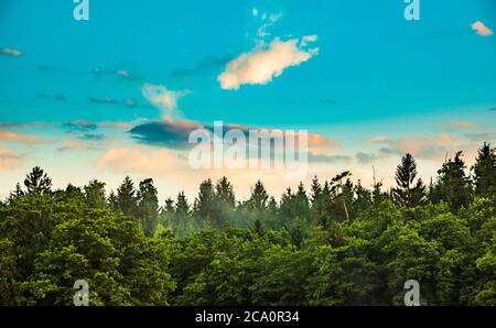 Panorama, sunset over fields and Austrian village with dramatic sky Stock Photo