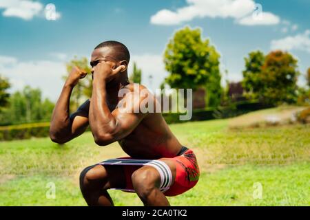 young athlete doing leg exercises Stock Photo