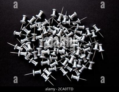 pins and stationery on a black background Stock Photo