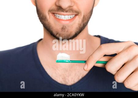 young man with green toothbrush care about health and caries Stock Photo