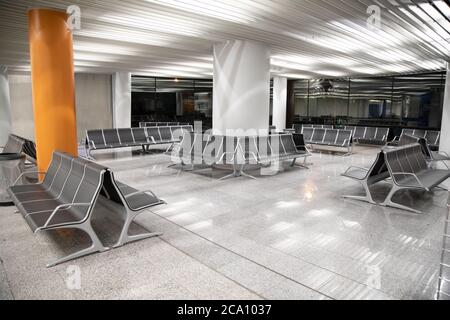 empty waiting room of airport in the dark at night without people on seats Stock Photo