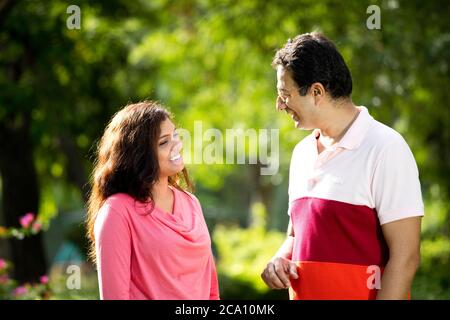 Mid adult couple discussing at public park Stock Photo