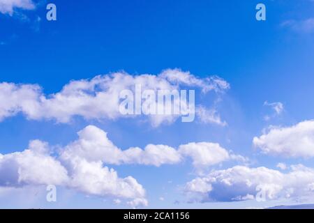 Nice white clouds on a sunny blue sky. Stock Photo