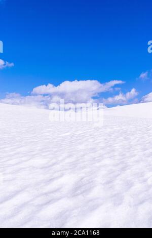 Great plain with snow on a sunny day with nice clouds. Stock Photo