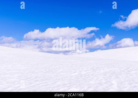Great plain with snow on a sunny day with nice clouds. Stock Photo