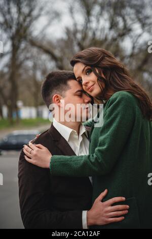 Close up of happy romantic attractive young couple hugging at the street Stock Photo