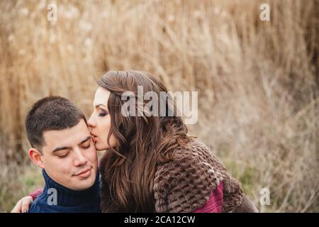 Close up of romantic attractive young couple hugging and kissing outdoors Stock Photo