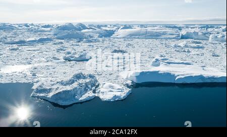 Iceberg aerial drone image - Global warming and climate change concept. Giant icebergs in Disko Bay on greenland in Ilulissat icefjord from melting Stock Photo