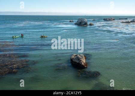 Kayaking along rocky shore, Pismo Beach, California coastline Stock Photo