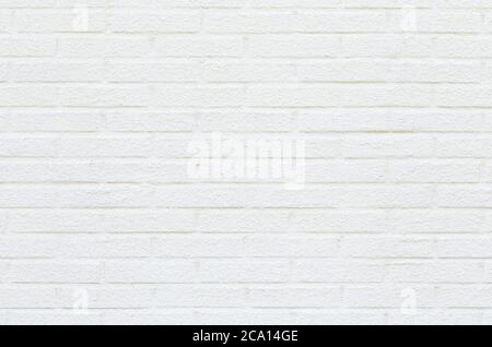 Close-up of a white new plastered brick wall viewed from the front. High resolution full frame textured background. Copy space. Stock Photo