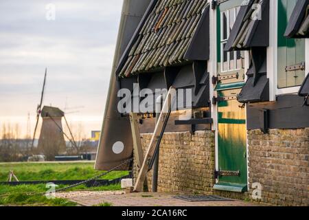 The Green Door of Windmill in Scenic Kinderdijk area of ponds, fields and windmills Stock Photo