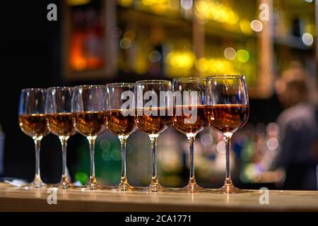 Lots of glasses of wine in a row at the bar counter Stock Photo