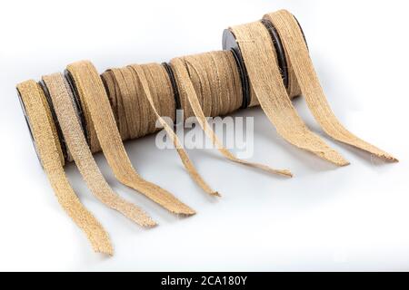 Colored jute ribbon rolls isolated on white background. Natural Braided Hemp Rope Vintage Linen Ribbon Roll, Linen Ribbon For Gift Wrap. Stock Photo