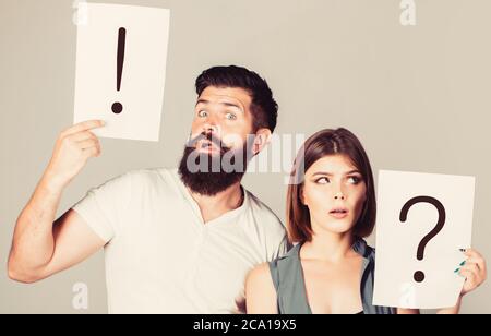 A woman and a man a question, exclamation point. Couple in quarrel. Question mark. Pensive man and a thoughtful woman. Husband and wife not talking Stock Photo