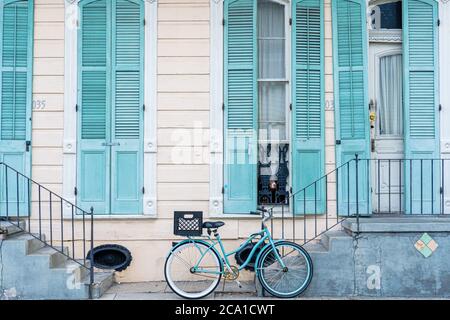 New Orleans, Louisiana/USA - 7/30/2020: French Quarter Home in Pastel Blue with Bicycle and Dogs in Window Stock Photo