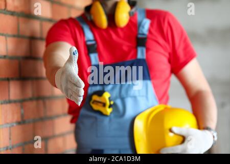 Builder at object holds out his hand for greeting Stock Photo
