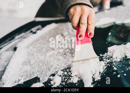 Female person hand with sponge scrubbing vehicle with foam, car