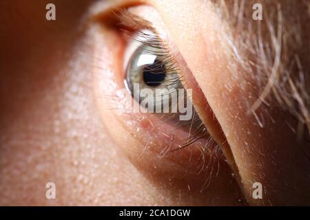 Male eyelashes extreme close-up in low light Stock Photo
