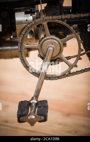Close up shot of a very old motorcycle pedals and chain. Stock Photo