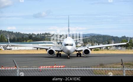 Sidney, British Columbia, Canada 03 Aug. 2020 - A Westjet Boeing 737-800 jet  taxis across the runway after landing at Victoria International Airport  Don Denton/Alamy Live News Stock Photo