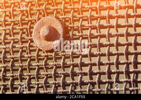 Rusty grid and large metal bolt Stock Photo