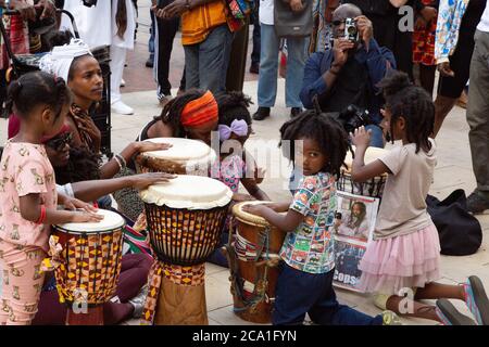 London UK 1st Agust 2020 Children play druns with their parents outside Black Cutural Archives in Windrush squarel during the annual Emancipation day. Emancipation Day marks the anniversary of the 1833 slavery abolition act Stock Photo