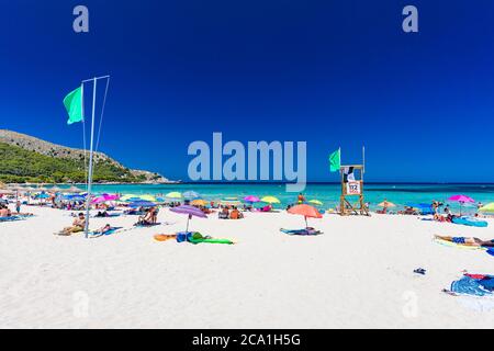 CALA AGULLA, MALLORCA, SPAIN - 21 July 2020: People enjoying summer on the popular sand beach on Mallorca,  Balearic Islands. Stock Photo