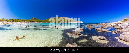 CALA AGULLA, MALLORCA, SPAIN - 21 July 2020: People enjoying summer on the popular sand beach on Mallorca,  Balearic Islands. Stock Photo