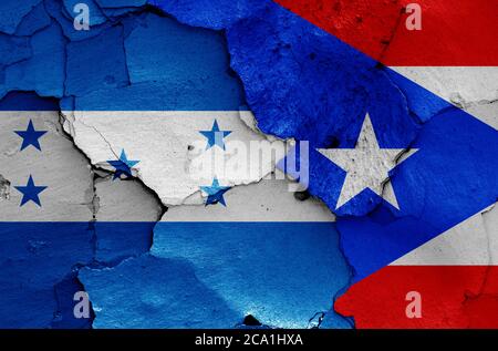 flags of Honduras and Puerto Rico painted on cracked wall Stock Photo