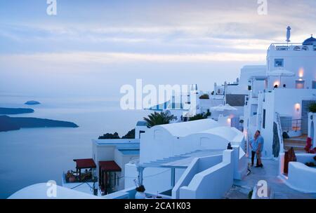 Couple enjoys a sea view from village of Thira. Santorini Greece Stock Photo