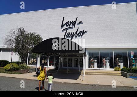 New York, USA. 3rd Aug, 2020. People walk toward a Lord & Taylor store in Long Island, New York, the United States, on Aug. 3, 2020. Lord & Taylor, one of America's oldest department stores, filed for bankruptcy protection on Sunday, joining a growing list of stores slammed by the COVID-19 pandemic. Credit: Wang Ying/Xinhua/Alamy Live News Stock Photo