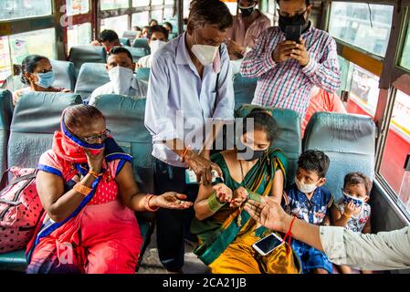 New Delhi, India. 03rd Aug, 2020. A bus conductor issues free tickets to only female passengers.Uttar Pradesh Government offers free ride for all women travelling today for Rakshabandhan (Rakhi), while travelling amid Covid-19 period the government arranged thermal screening and hand sanitizer at the Bus Depot as well as inside the buses. Credit: SOPA Images Limited/Alamy Live News Stock Photo