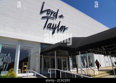 Beijing, USA. 3rd Aug, 2020. A woman walks past a Lord & Taylor store in Long Island, New York, the United States, on Aug. 3, 2020. Lord & Taylor, one of America's oldest department stores, filed for bankruptcy protection on Sunday, joining a growing list of stores slammed by the COVID-19 pandemic. Credit: Wang Ying/Xinhua/Alamy Live News Stock Photo