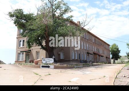 An Old Abandoned Apartment Building Atop A Hill In Bisbee, Arizona. Stock Photo