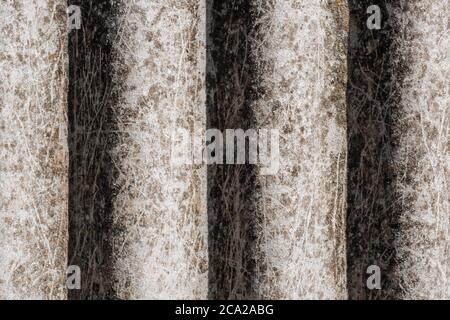 Vintage texture of an old corrugated asbestos slate covered with moss. The texture of the old roof. Close up Stock Photo