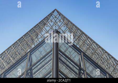 Paris, France - June 27, 2019: View of pyramid at courtyard of Louvre Museum. Louvre Museum is one of the largest and most visited museums worldwide. Stock Photo