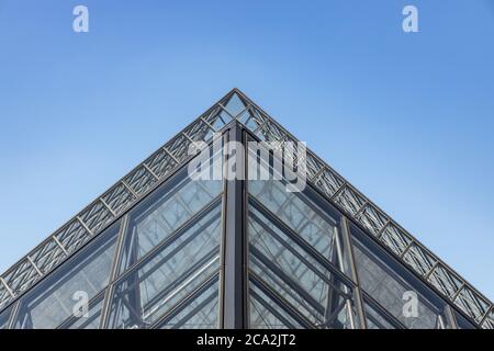 Paris, France - June 27, 2019: View of pyramid at courtyard of Louvre Museum. Louvre Museum is one of the largest and most visited museums worldwide. Stock Photo