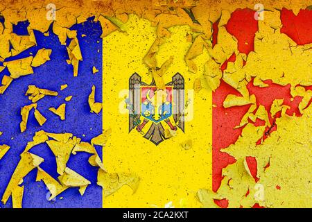 The national flag of Moldova  is painted on an old metal wall with ragged paint. Country symbol. Stock Photo