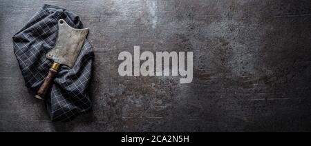 Old meat butcher on dark concrete board - top of view Stock Photo
