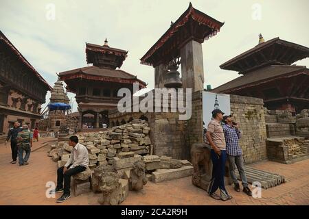 Men having leisure time at the historic Bhaktapur Durbar Square in Bhaktapur, Nepal, one year after the 2015 earthquakes. © Reynold Sumayku Stock Photo