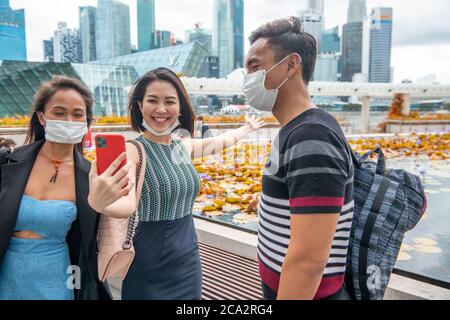 Group of three asian people outdoor wearing face mask. Stock Photo