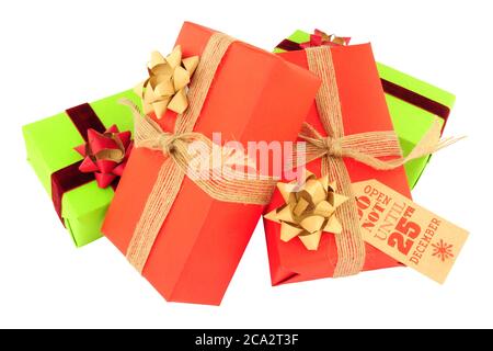 Christmas parcels wrapped in red and green paper with ribbons and bows isolated on a white background Stock Photo