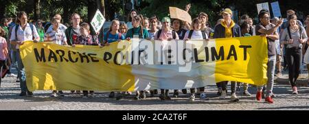 Strasbourg, France - Sep 21, 2019: Front view of large group of people climate change activists with yellow protest placard banner as main inscription Marche pour le Climat - Climate March protest Stock Photo