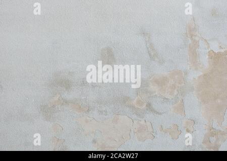 Cracked gray cement wall. Dirty gray concrete texture as background. Empty exposed concrete surface. Abstract grey crumbled cement backdrop. Texture o Stock Photo