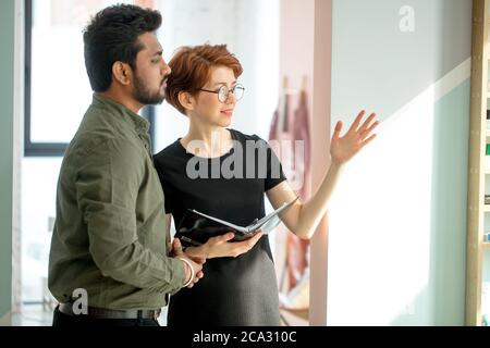 Two business people discussing about work in office Stock Photo