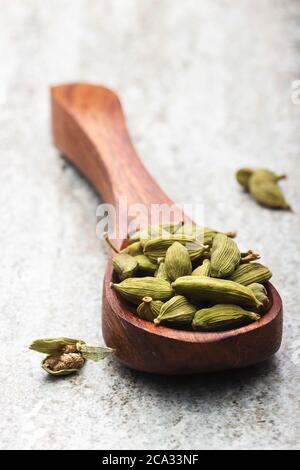 Close up image of cardamom in wooded spoon Stock Photo